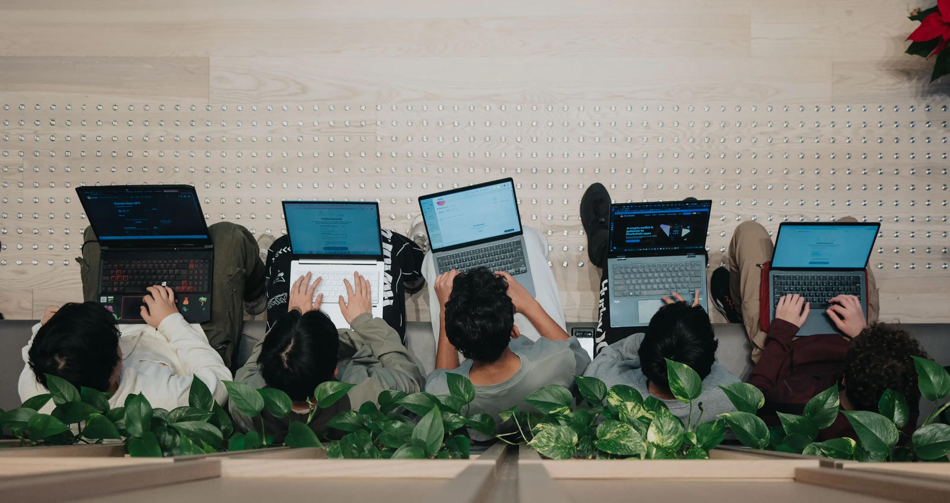 students in the lobby working on laptops
