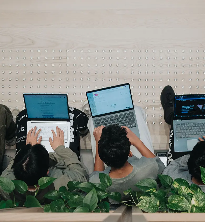 students in the lobby working on laptops