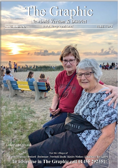Front cover of The Graphic magazine. Two older women smiling and sitting on a beach at sunset with other people and benches in the background.