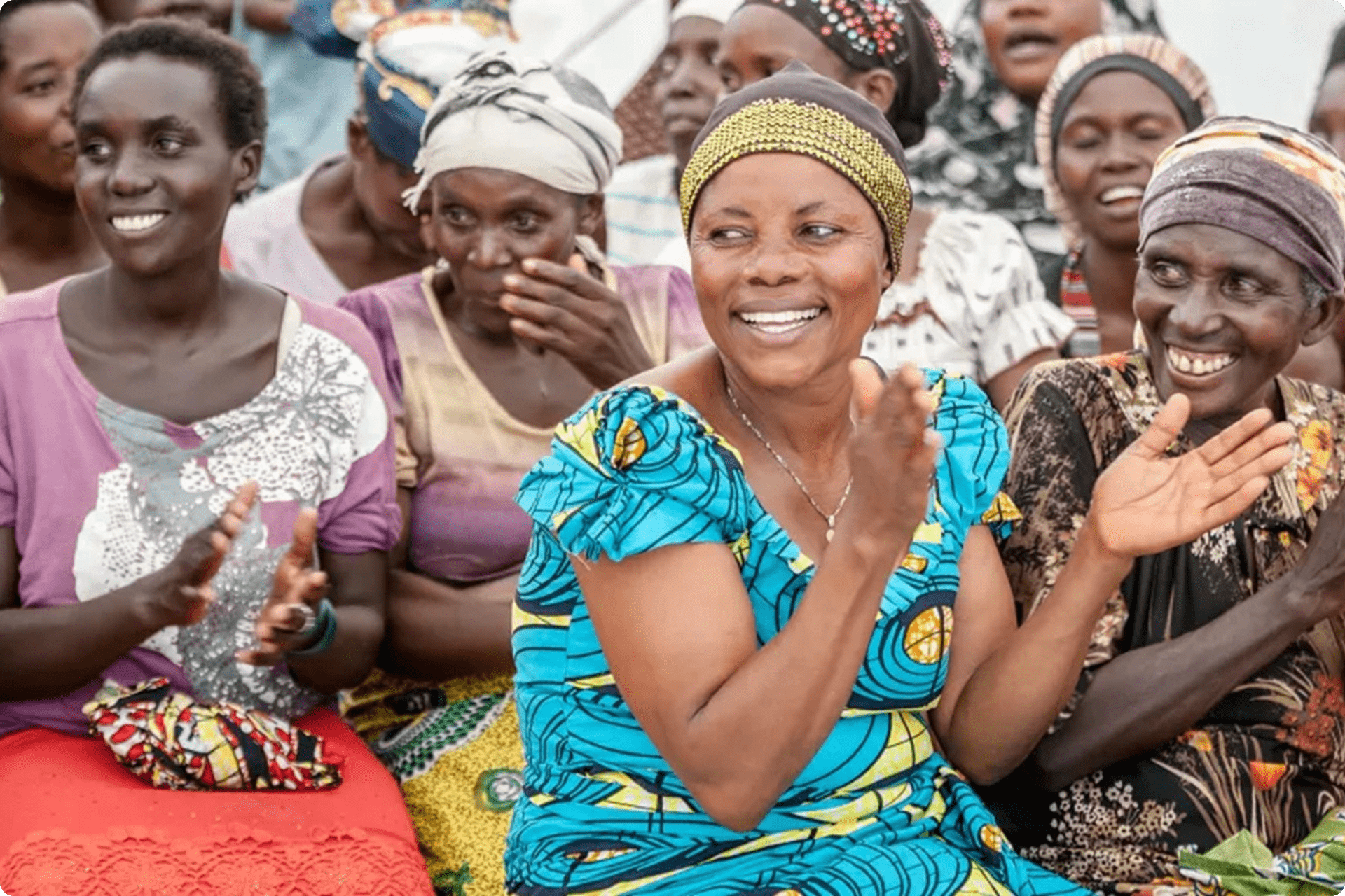 Women sitting at a community gathering.