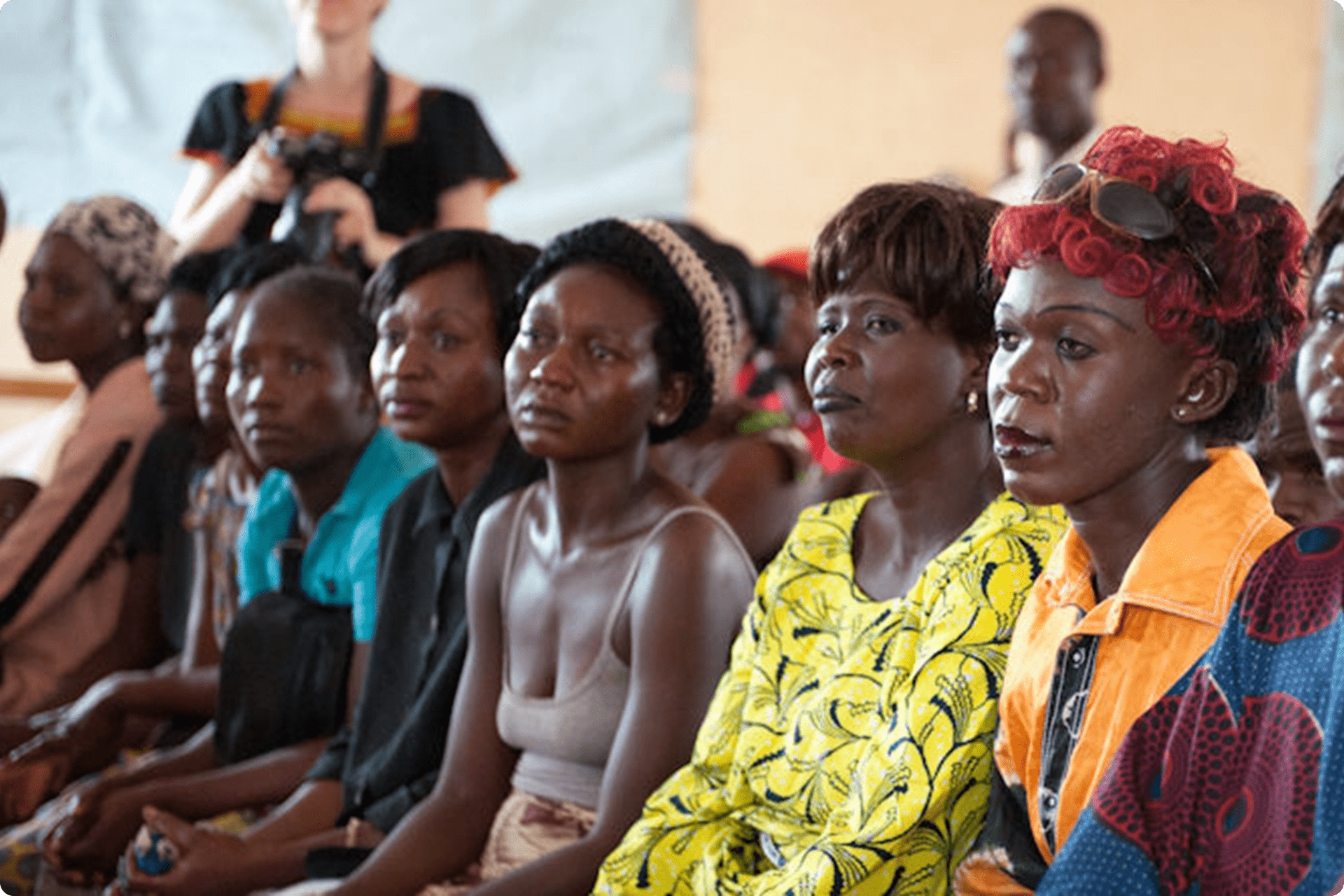 Women sitting at the community gathering.