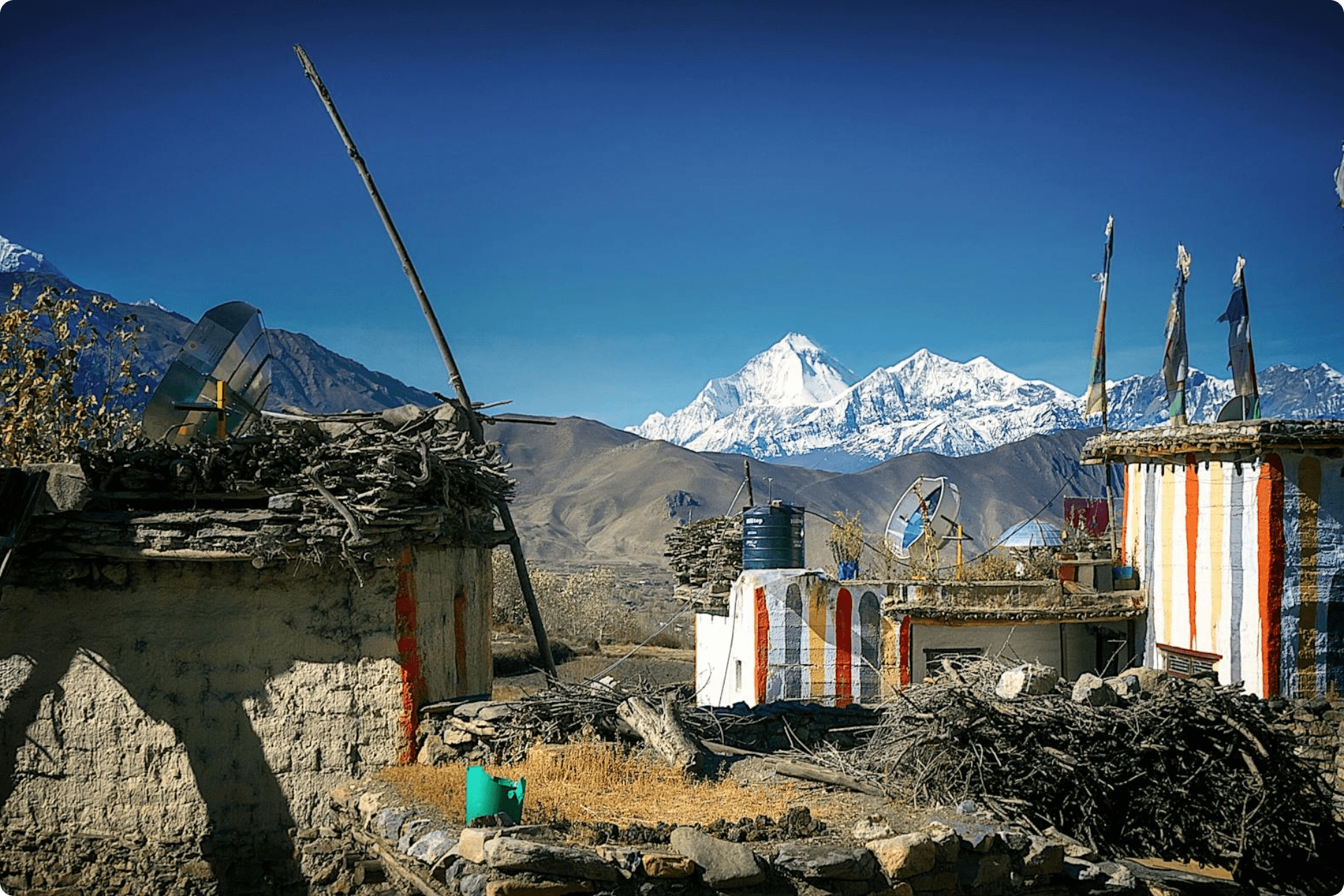 A rural mountainous village with traditional stone and mud houses.