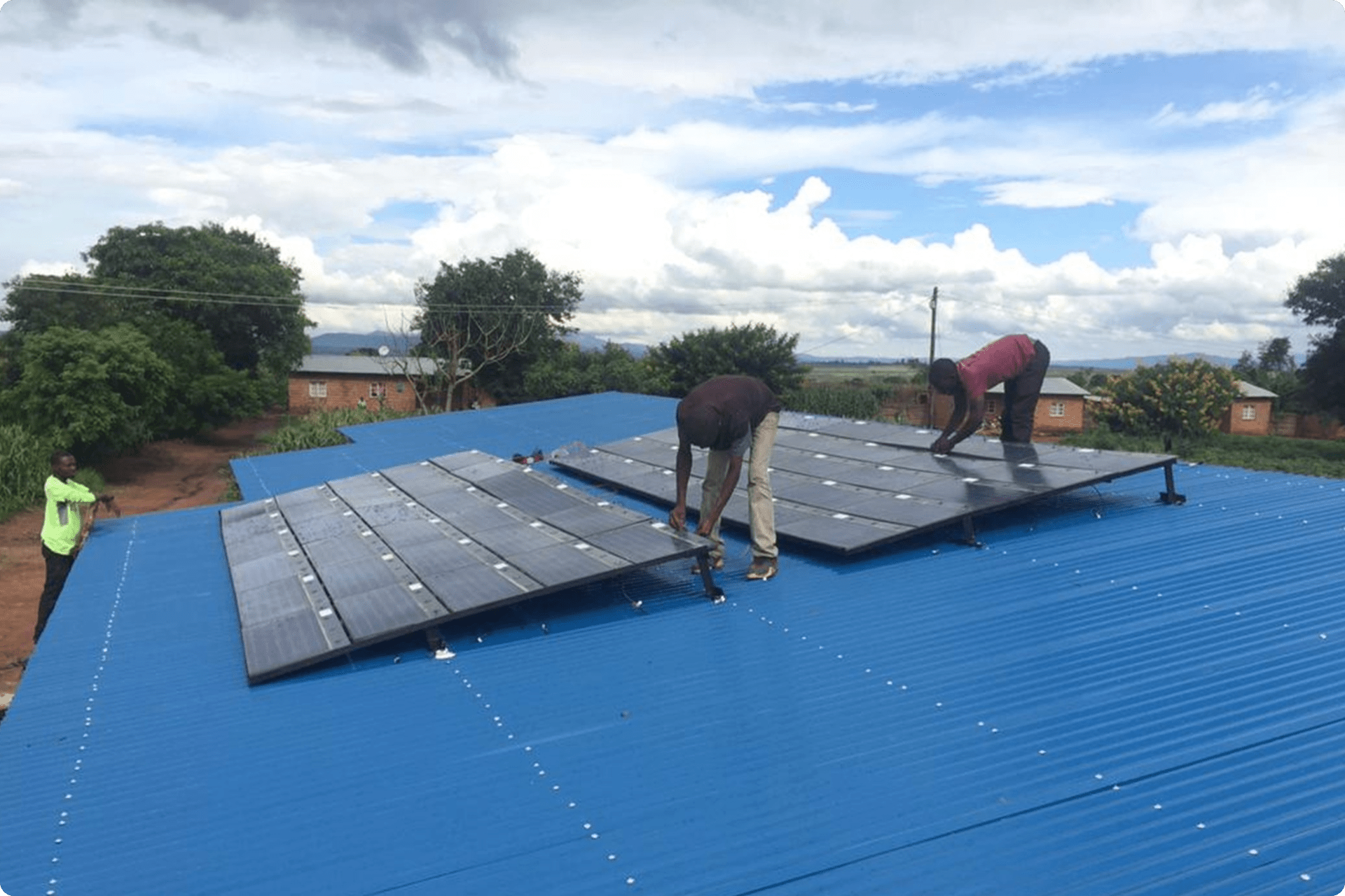 People installing solar panels on a roof.