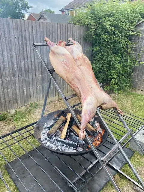 Lamb about to be cooked South American style over a fire pit