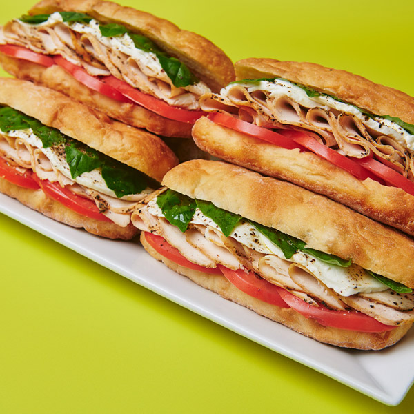 A fresh take on a classic Caprese sandwich, layered with grilled chicken, mozzarella, ripe tomatoes and basil.