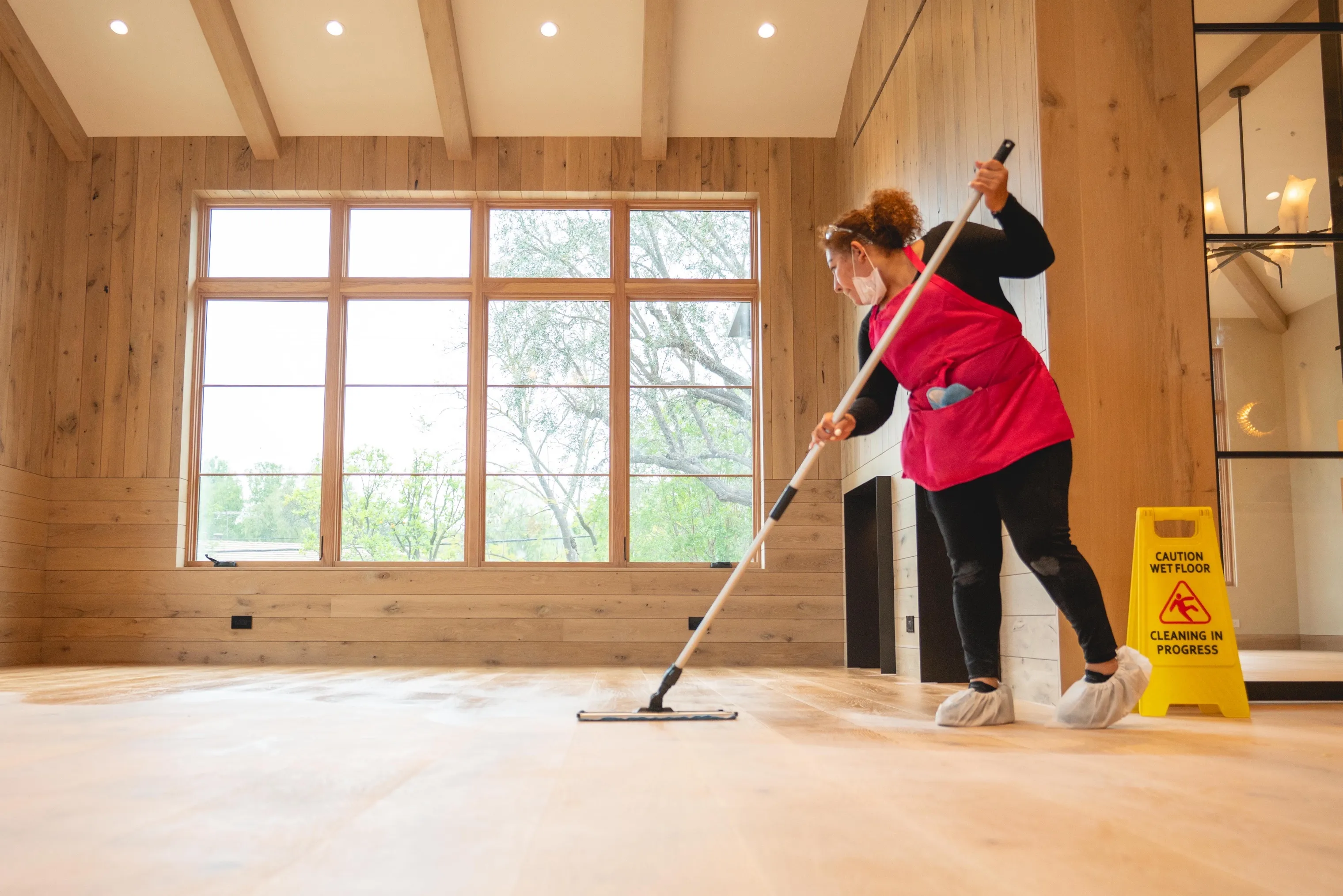 cleaning lady in luxury santa monica home mopping floor