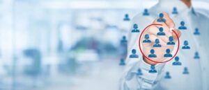 Hand circling target icons, representing how NDIS providers can identify and attract participants.