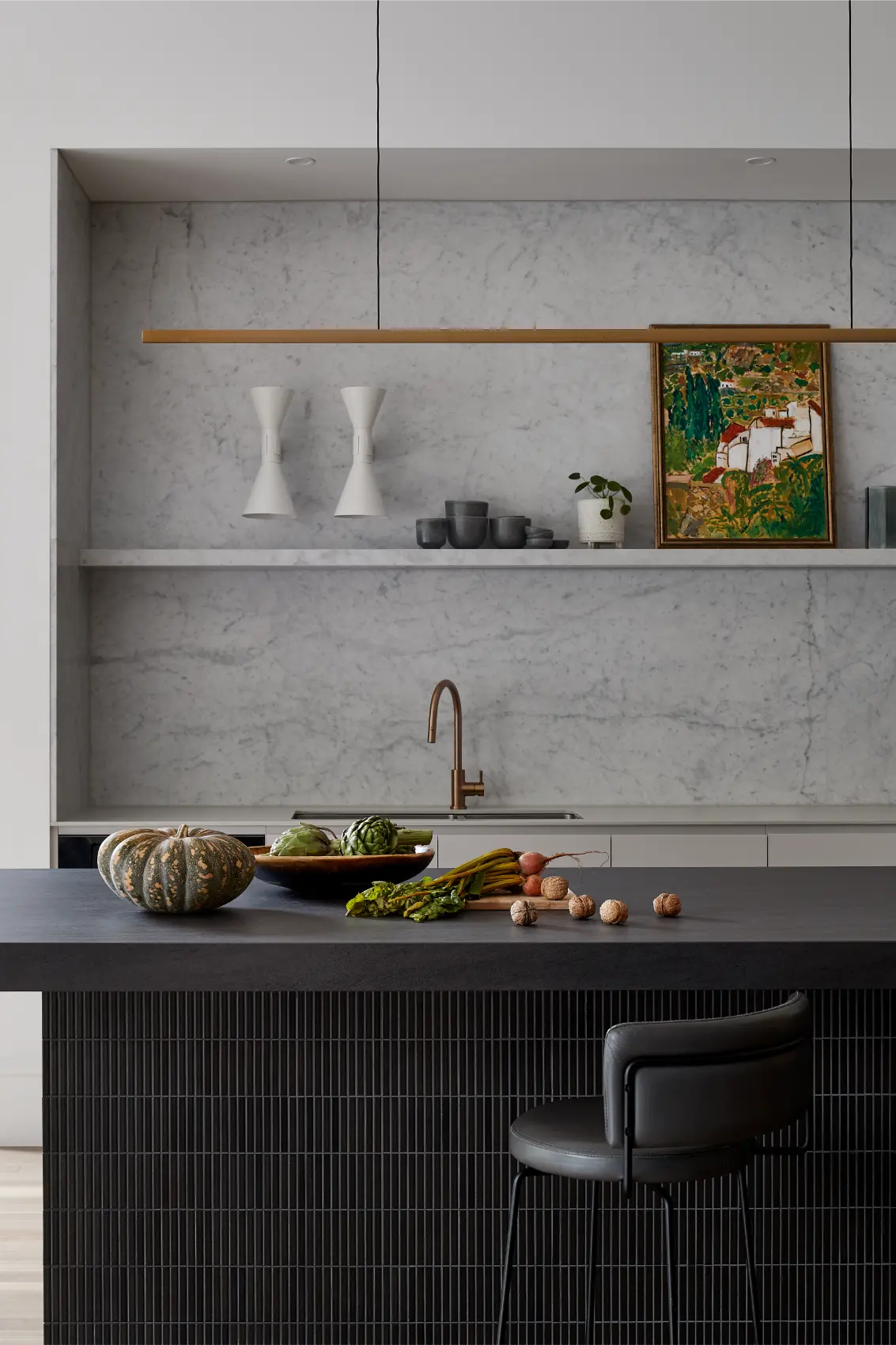 Kitchen detail with stone benchtop and shelving in an architectural home in Melbourne.