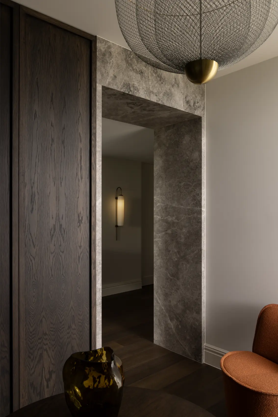 Stone-lined interior entry with custom joinery and architectural lighting in a Melbourne home.