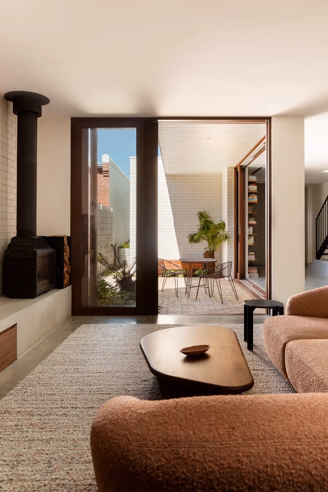 Living area opening to an outdoor courtyard in an architectural home in Melbourne.