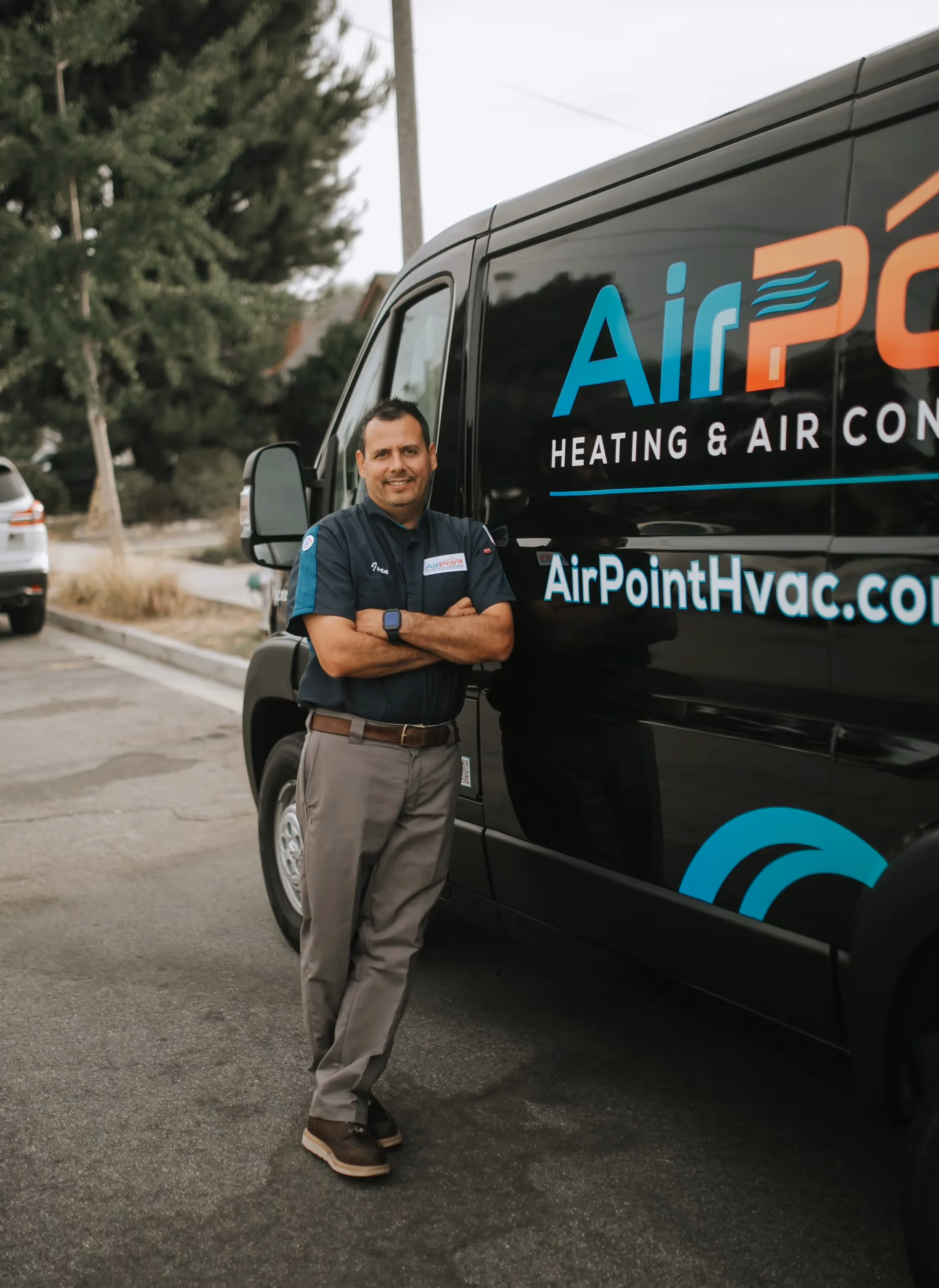 AirPoint HVAC technician standing next to company service van