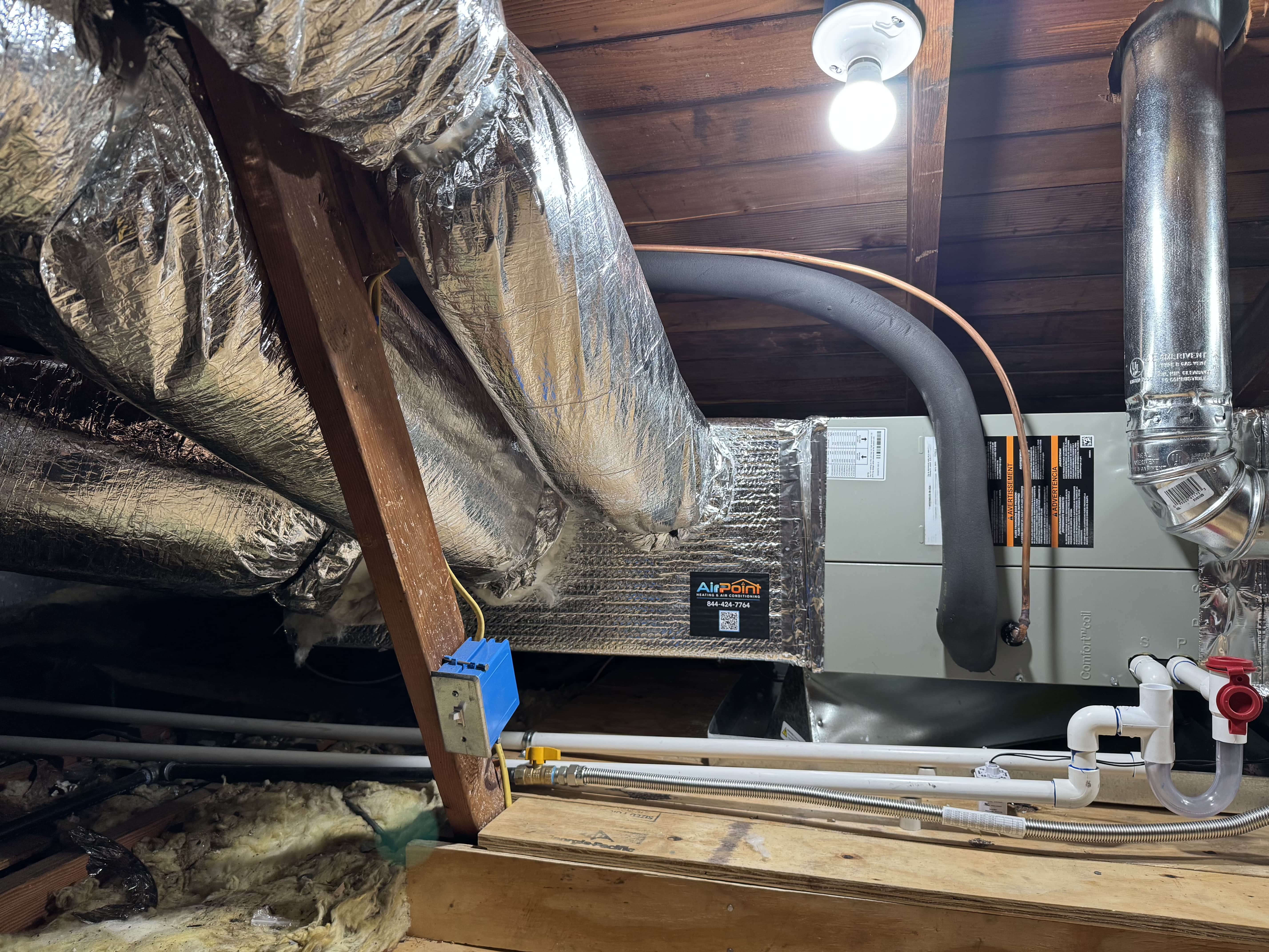 HVAC system with insulated ductwork in a wooden attic or crawl space