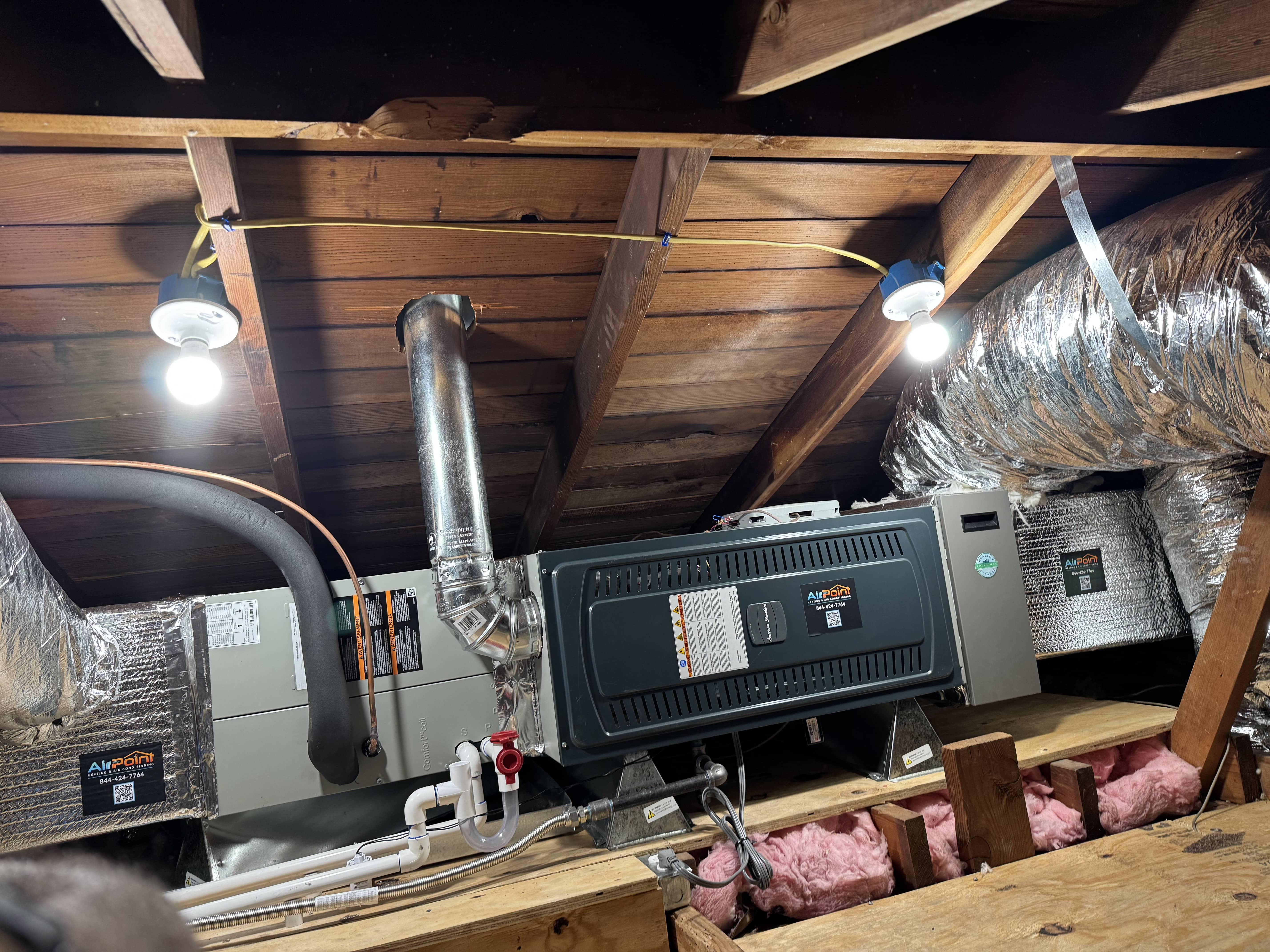 Airpoint HVAC system installed in wooden attic with insulation and ductwork