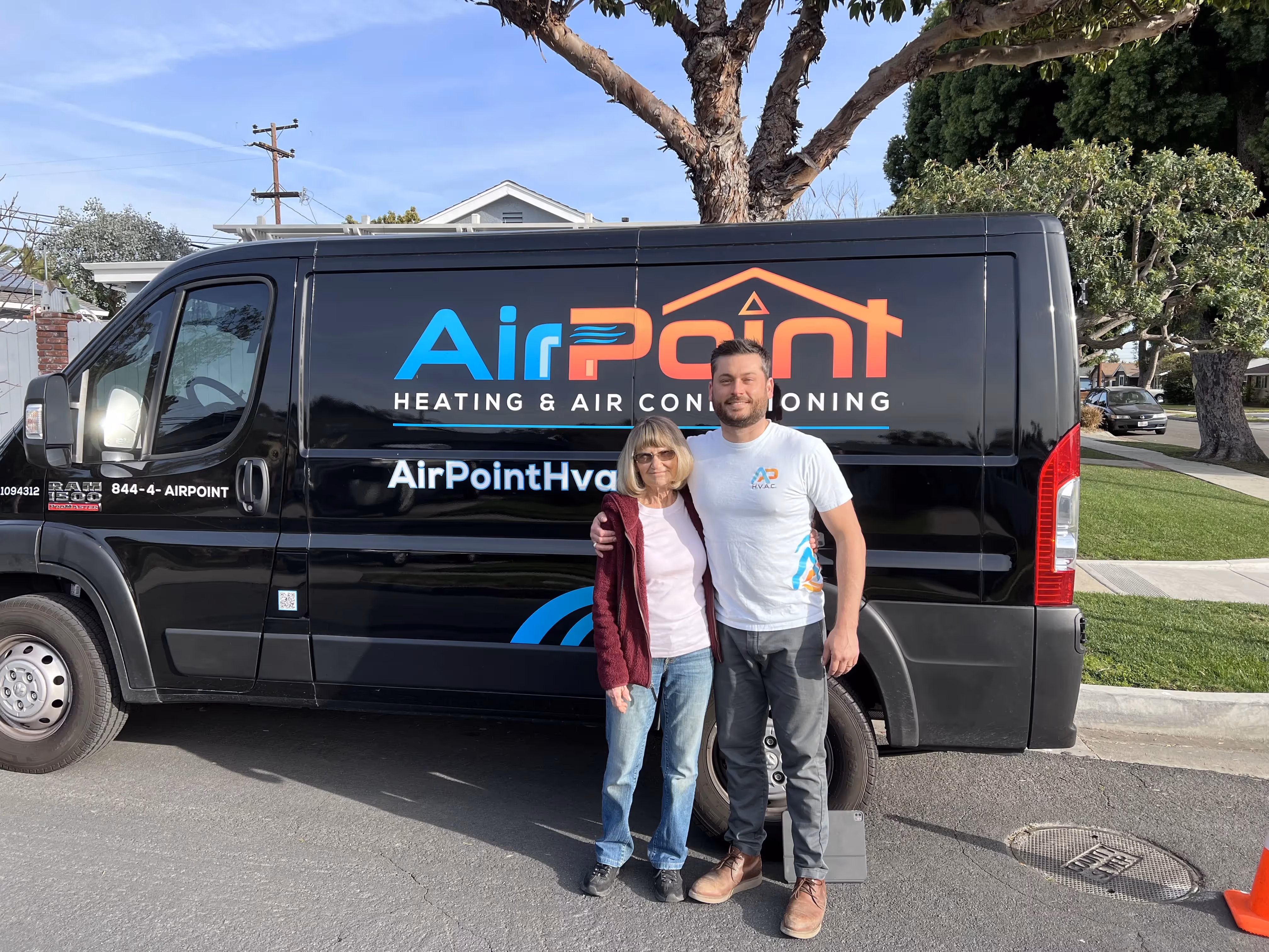 AirPoint Heating and Air Conditioning van with two workers outside