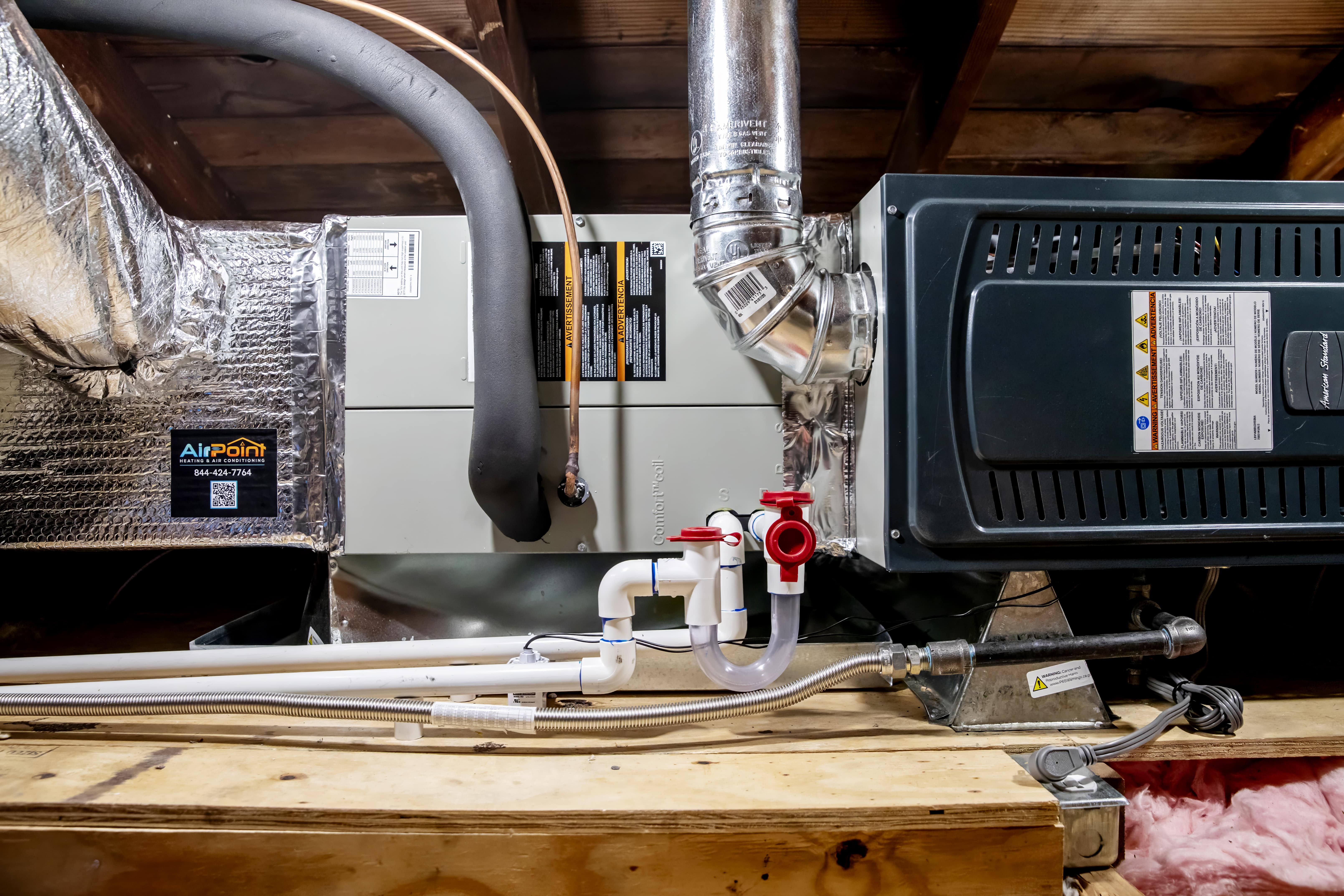 HVAC system with pipes, insulation, and equipment in utility room