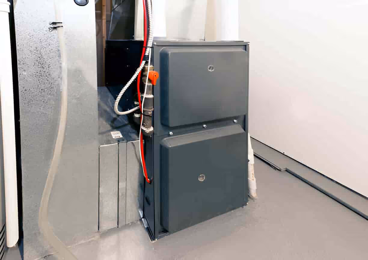 Gray electrical box with red wire installed in industrial or utility setting