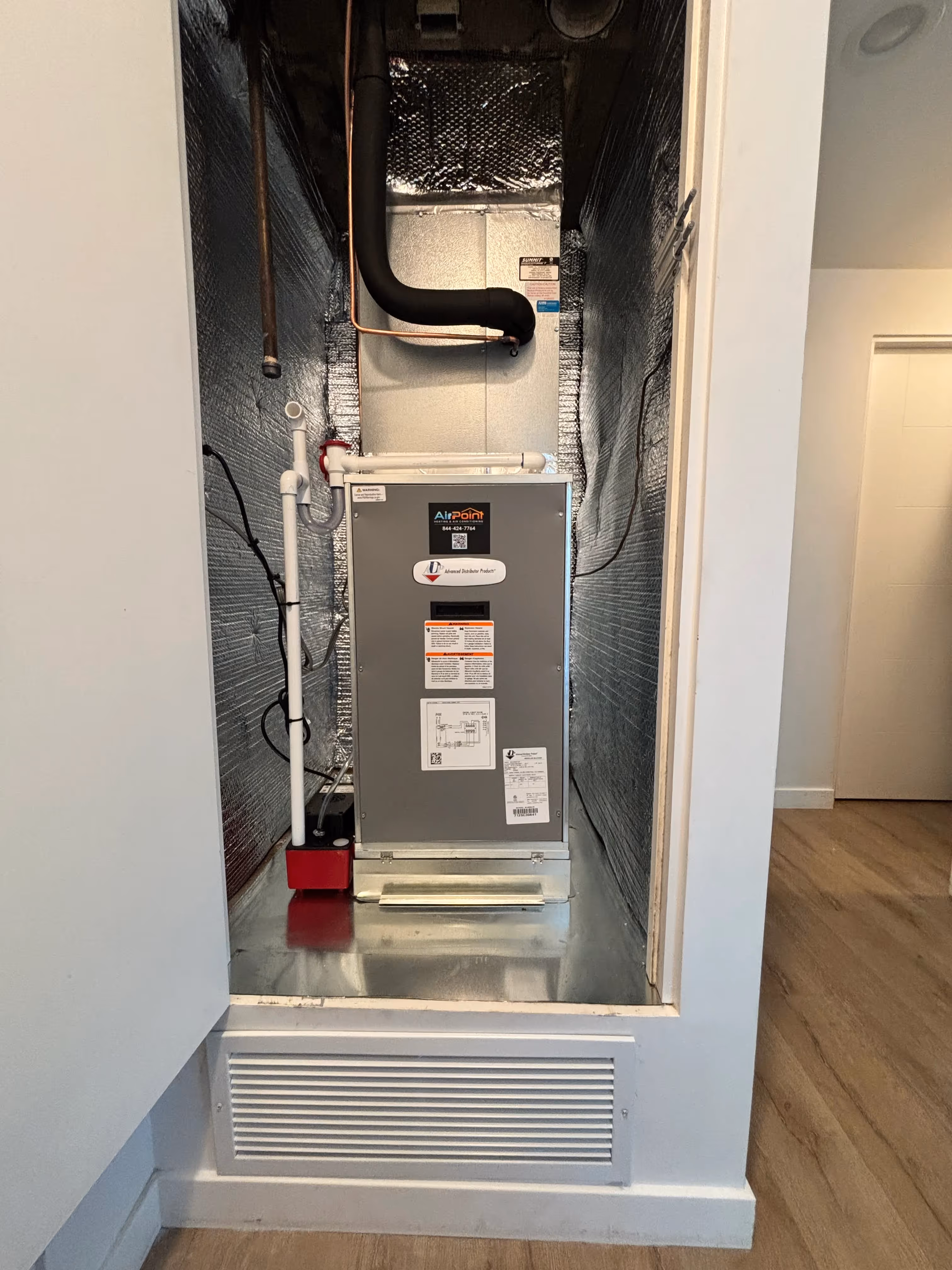 AirPoint water heater installed in a compact utility closet with pipes