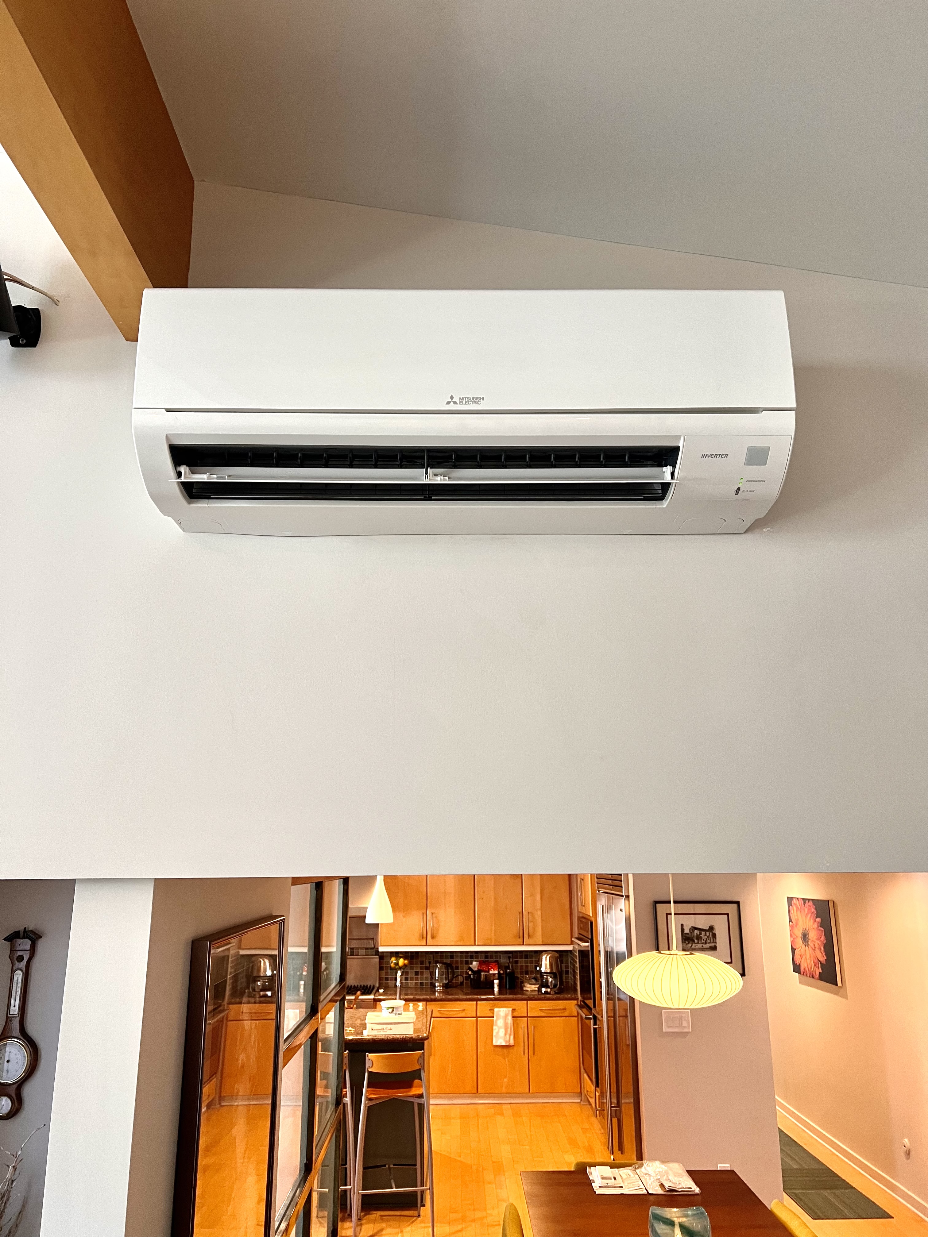 White Mitsubishi ductless mini-split air conditioner mounted on wall