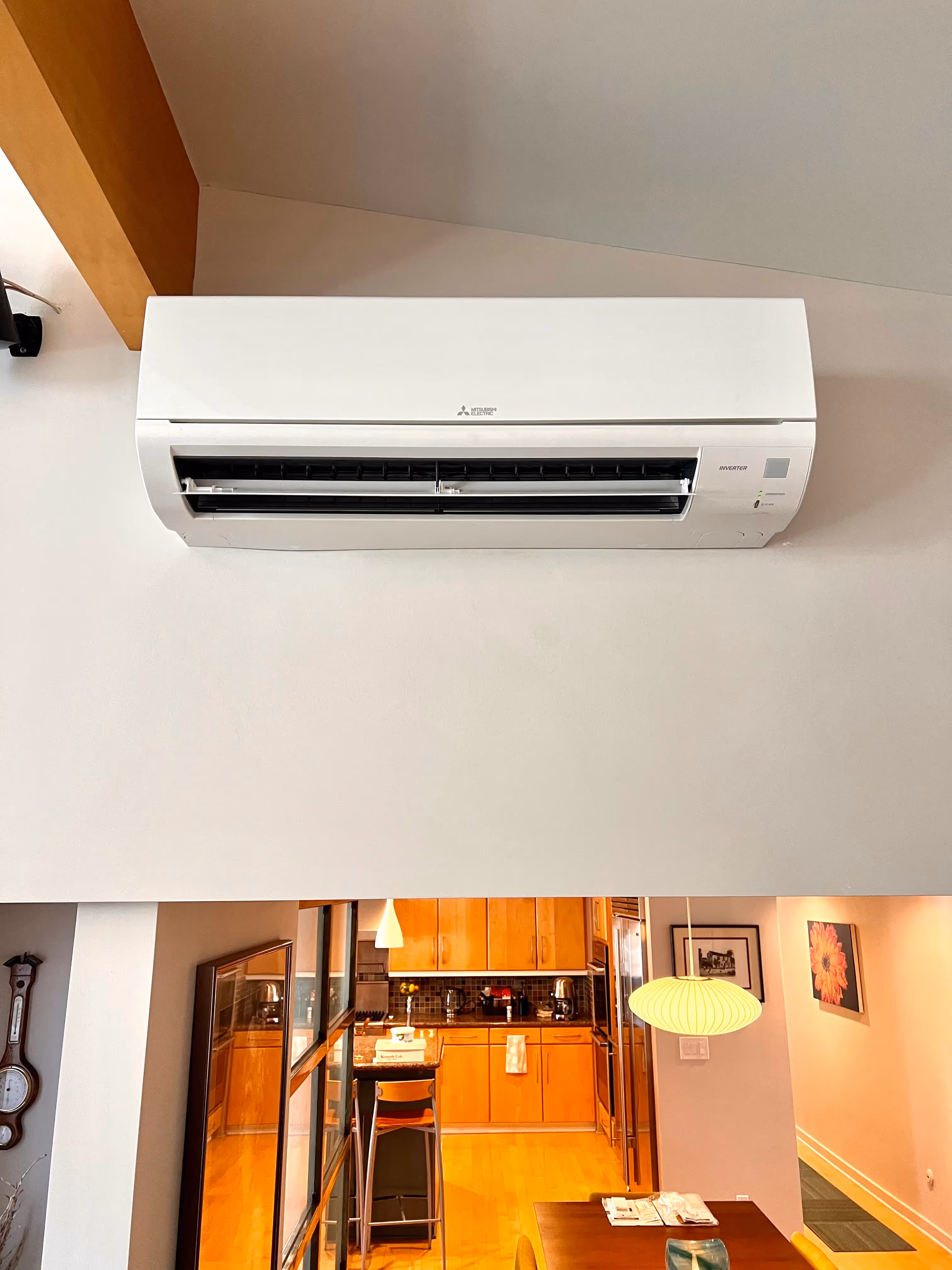White Mitsubishi ductless mini-split air conditioner mounted on wall