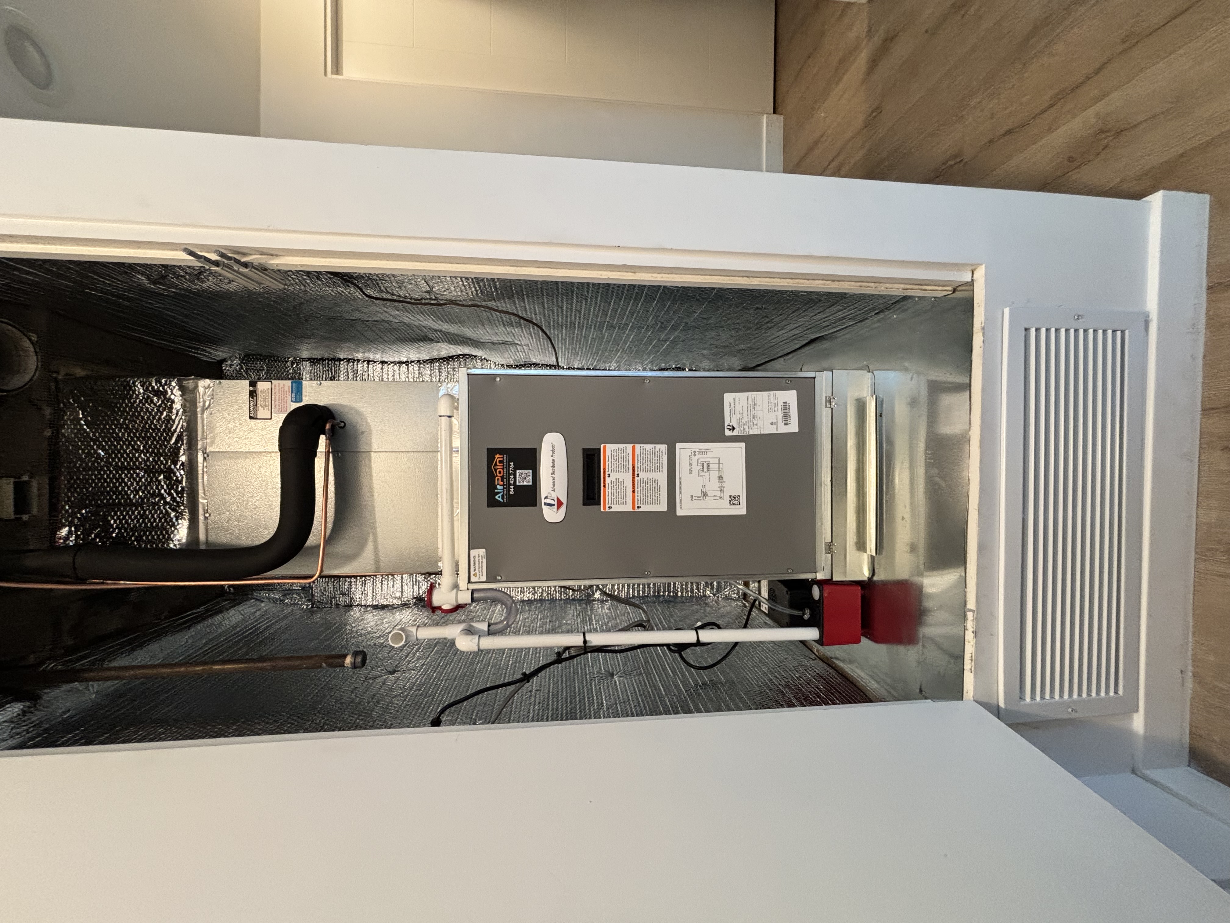 Air Point water heater installed in a narrow utility closet with ventilation