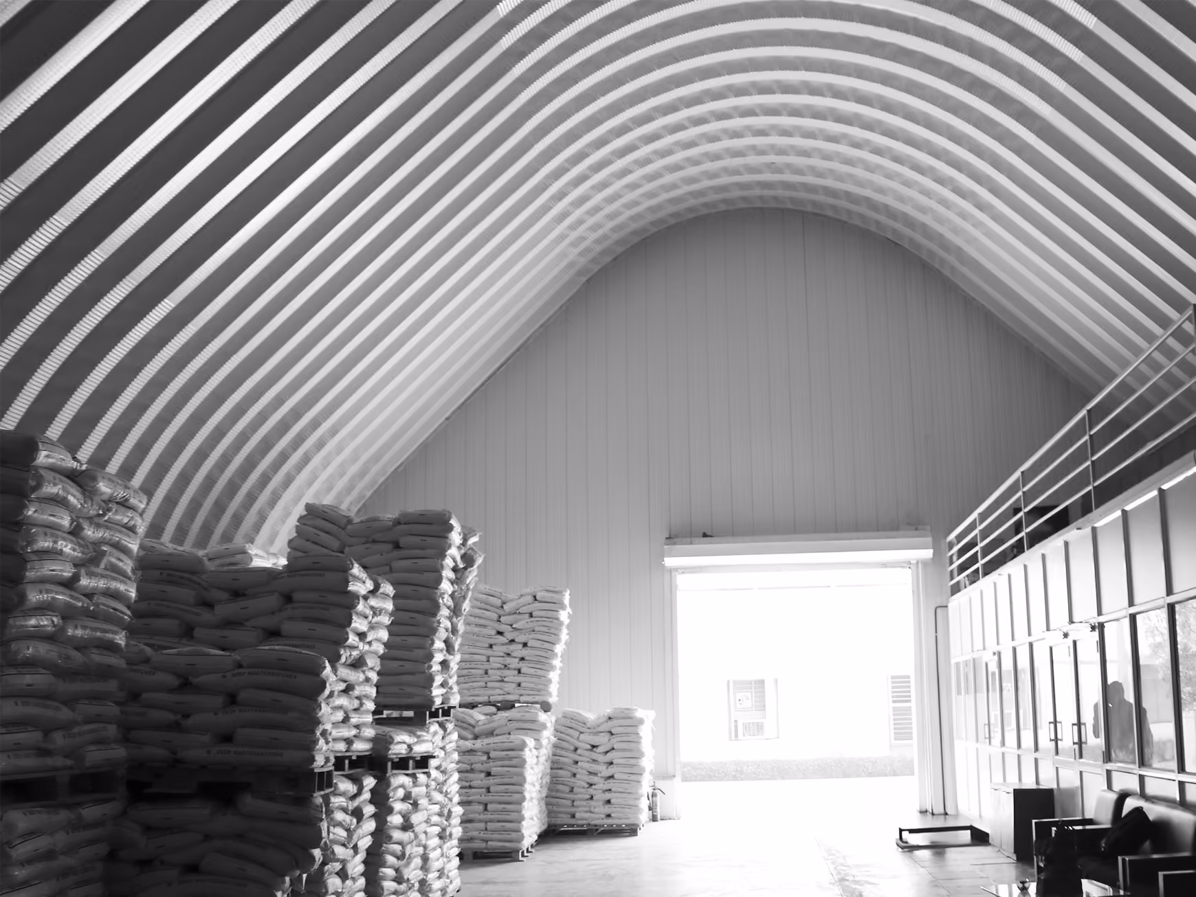 Interior of A-shaped steel building with stacked sacks