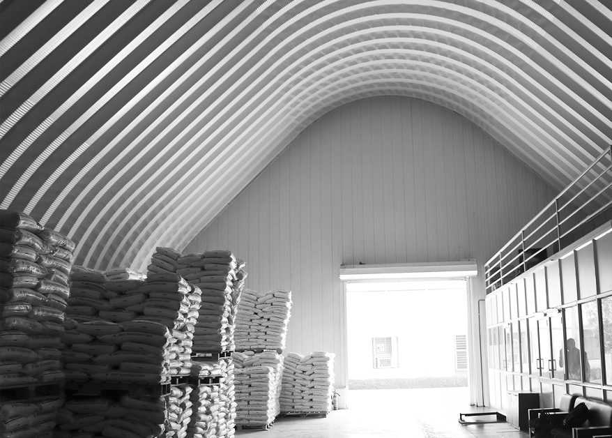 Interior of A-shaped steel building with stacked sacks