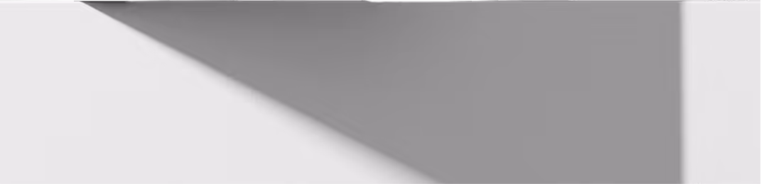White wall with a shadow cast diagonally across it.
