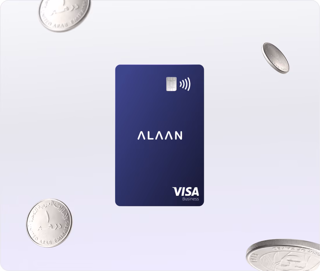 Blue ALAAN Visa Business credit card with contactless payment symbol in the center surrounded by floating coins.