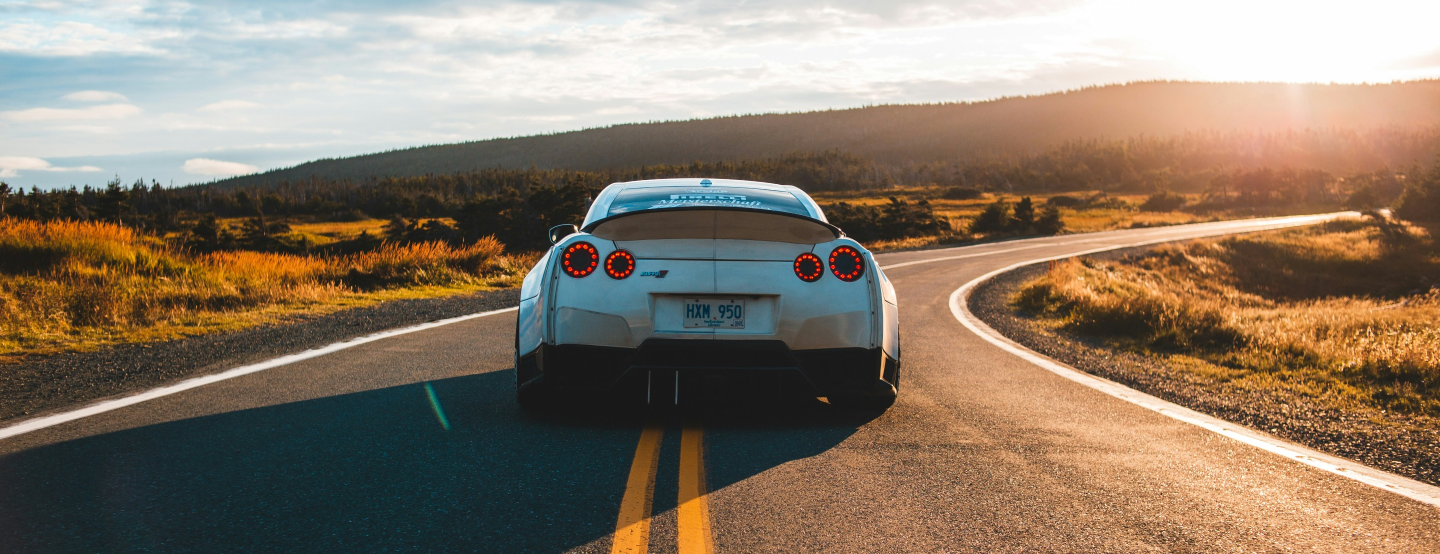 White sports car on a mountain road