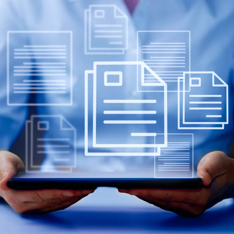 Person holding a tablet with floating digital document icons above it.