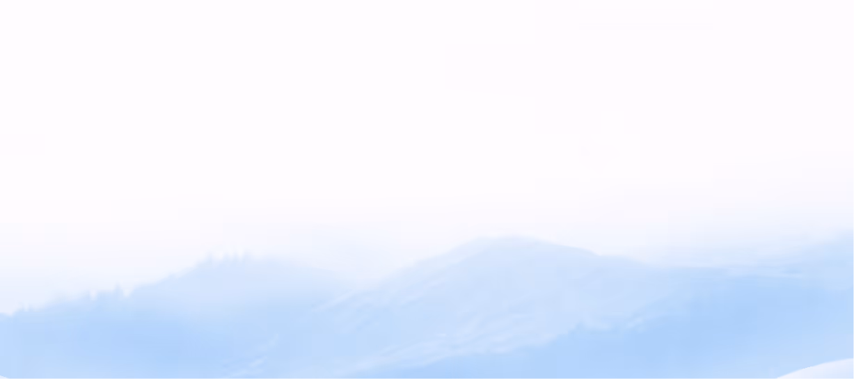 Soft blue layered mountain silhouettes fading into a misty white sky.