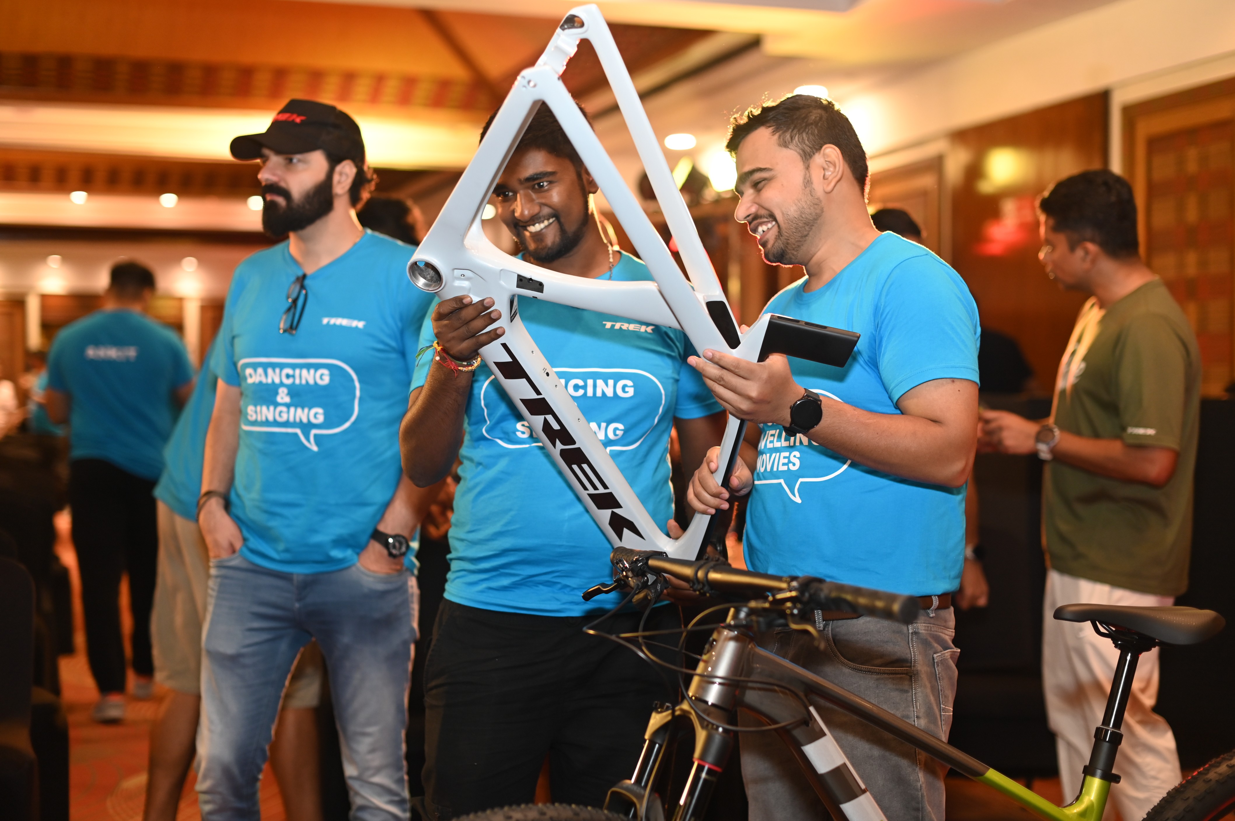 Corporate team building exercise with Trek employees working together on a cycle frame, demonstrating intentional offsite experiences