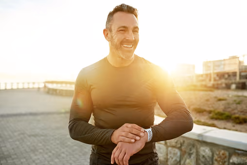 A man in athletic gear preparing to go for a run outside
