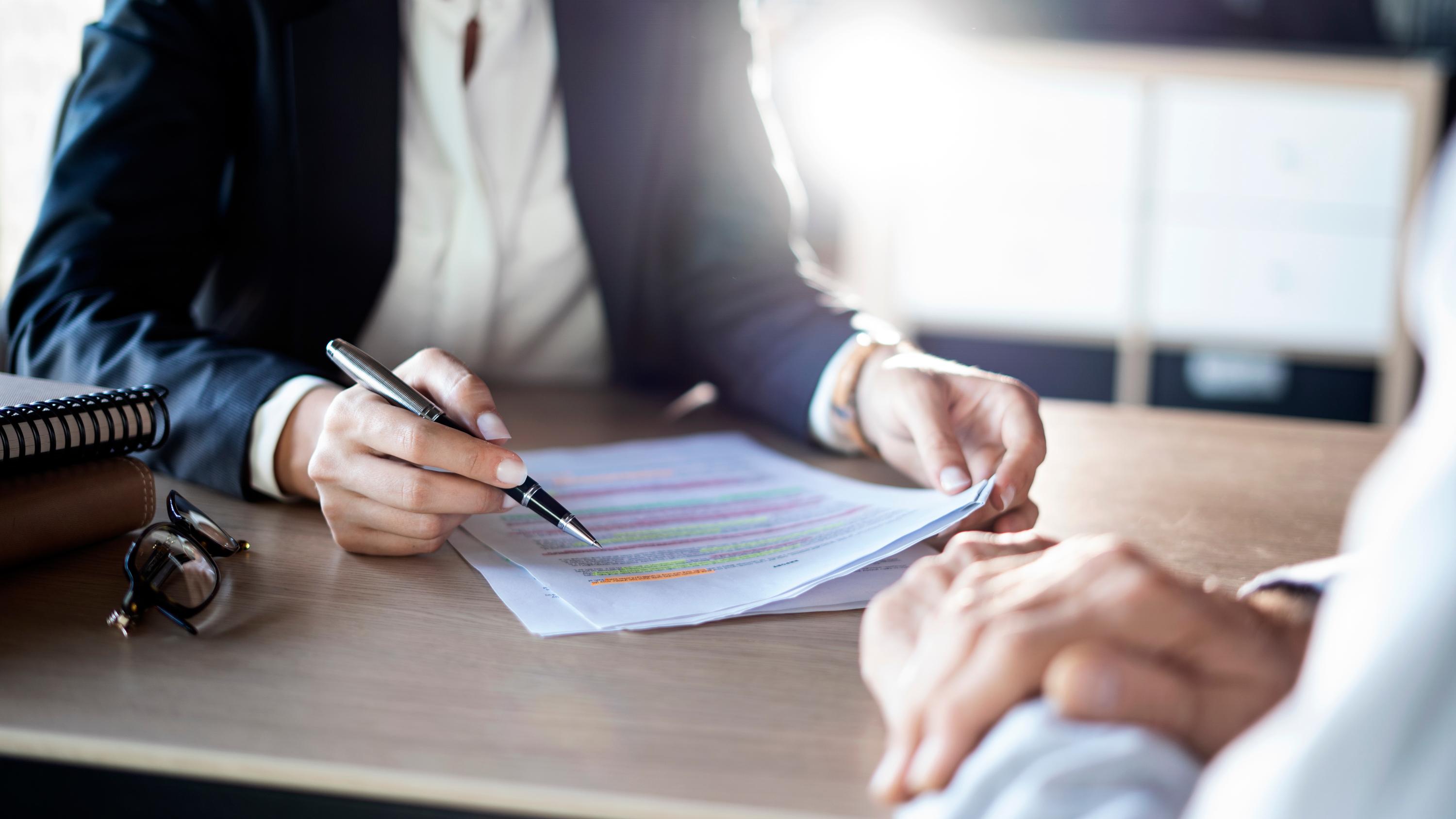 Business professionals reviewing financial documents