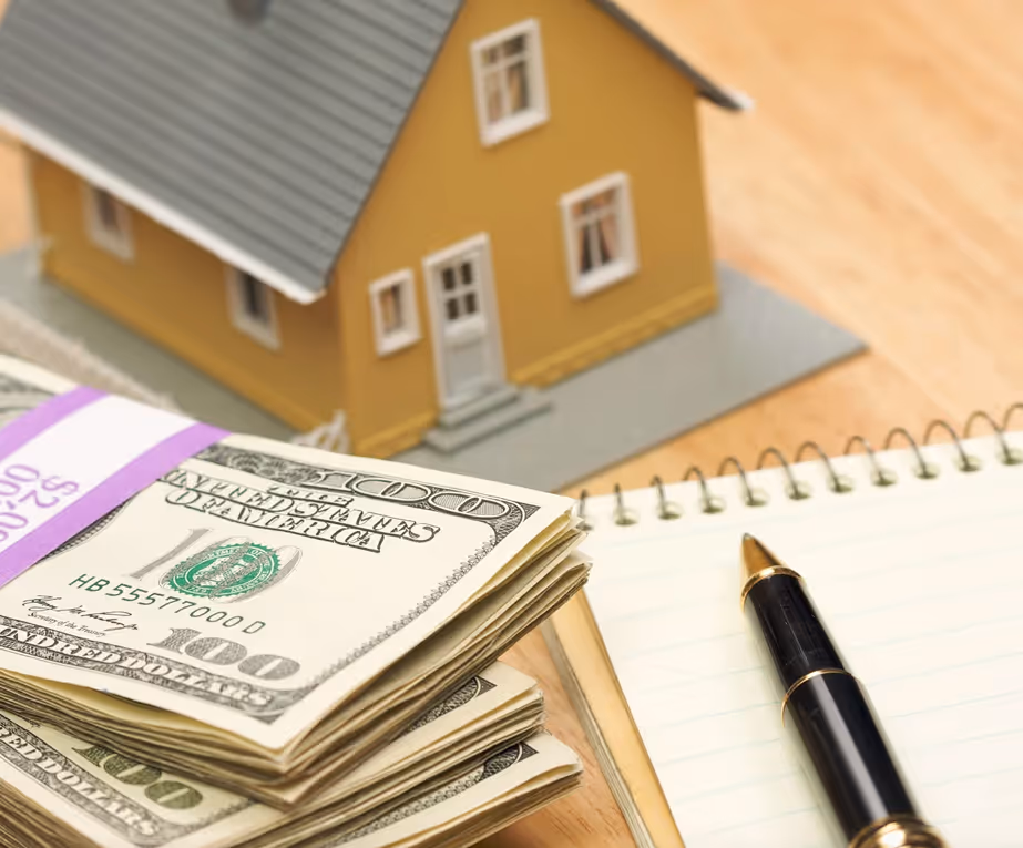 Cash in front of a house model