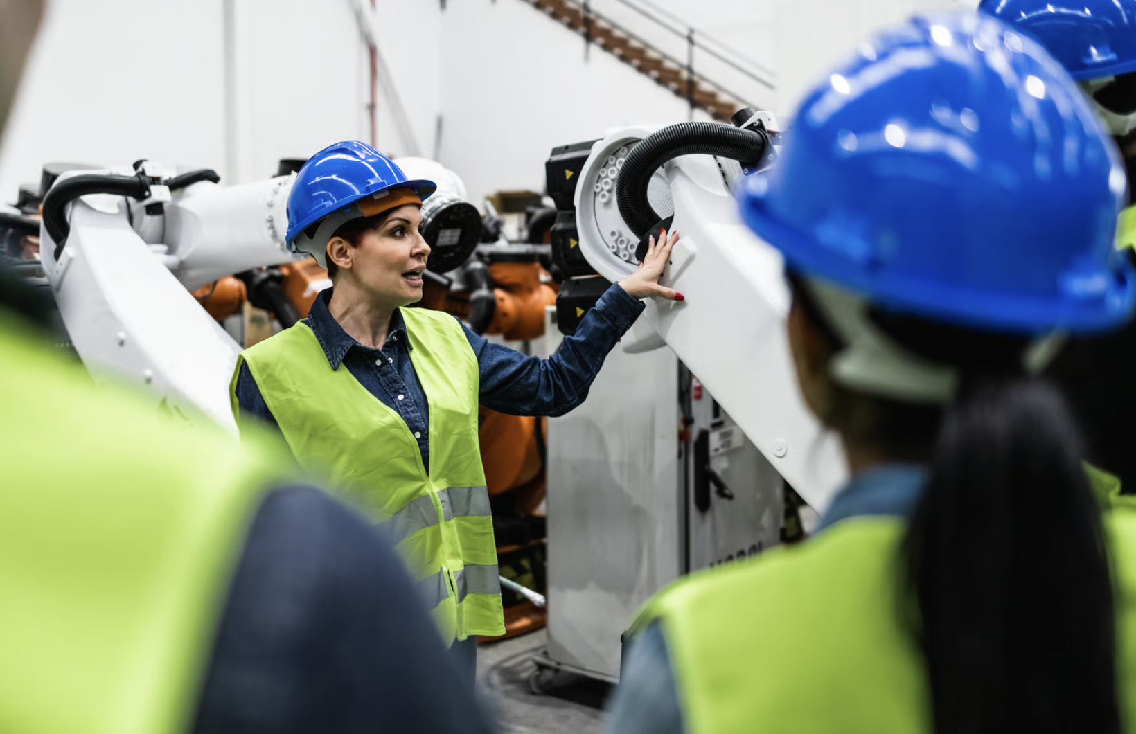 Team of engineers working in robotic factory - Tech industry concept