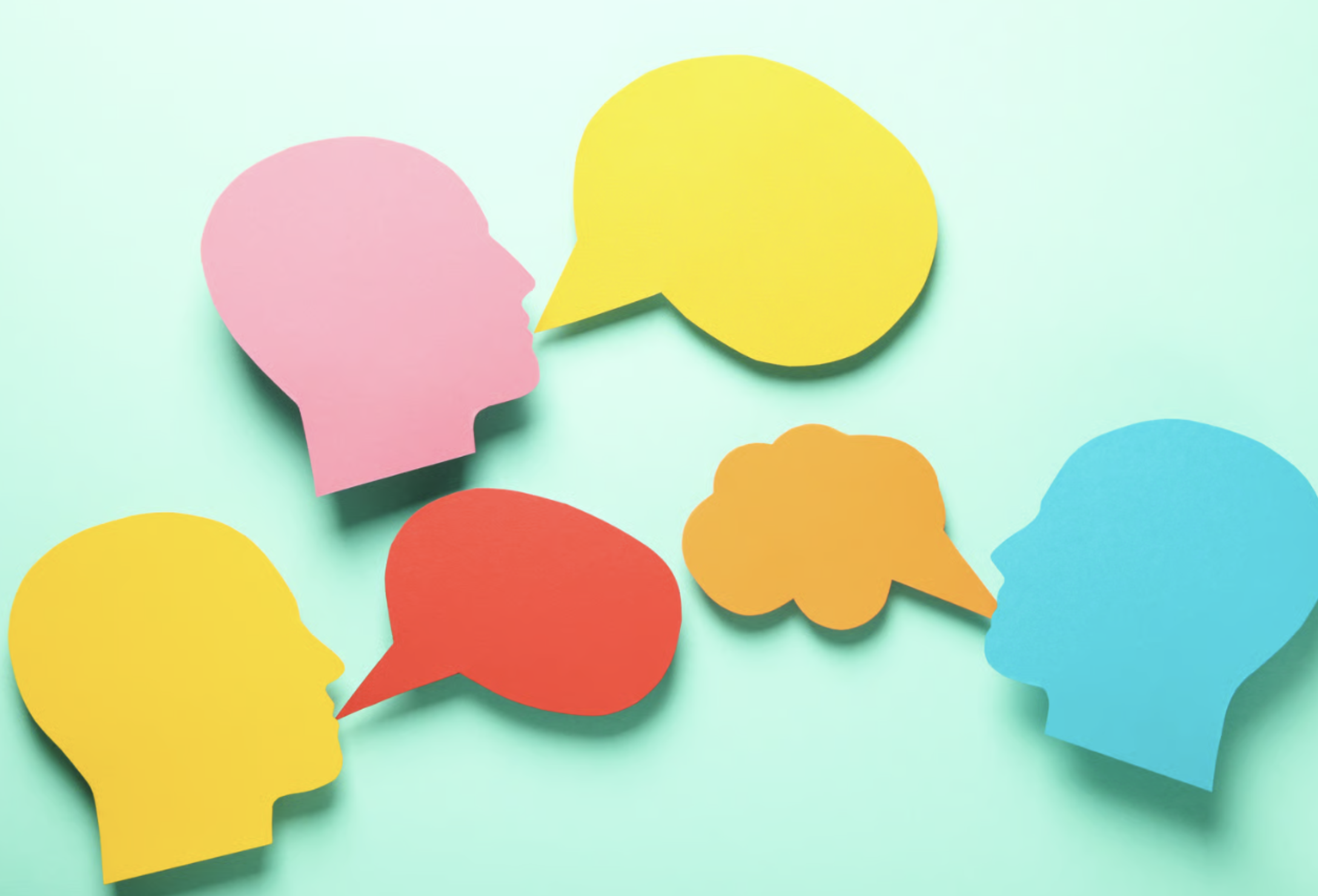 Colorful Head Silhouettes with Speech Bubbles on Background