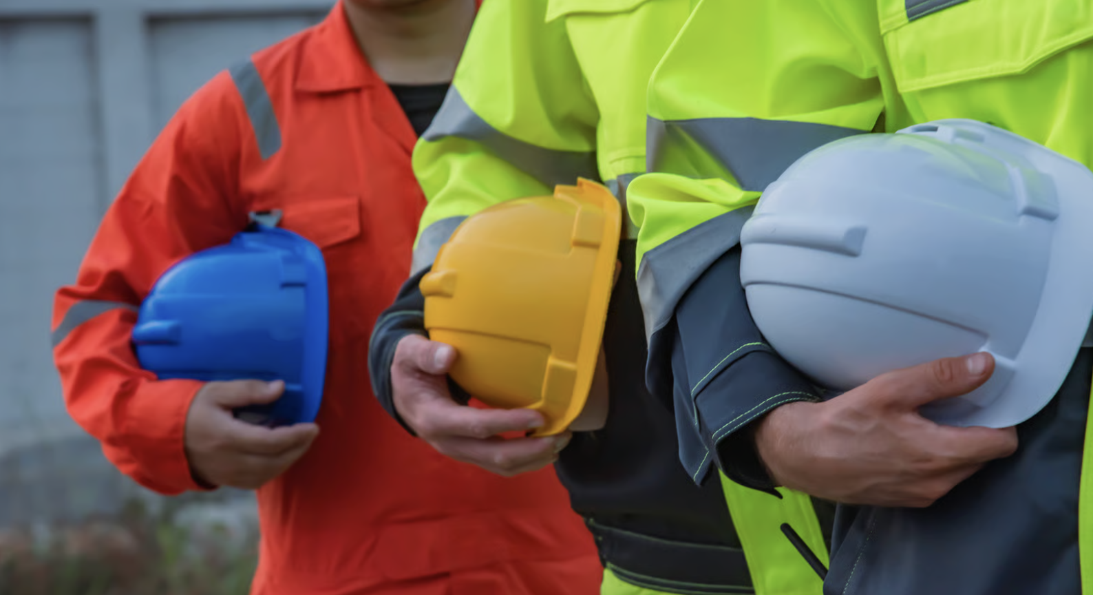 Construction Workers Holding Colorful Hard Hats