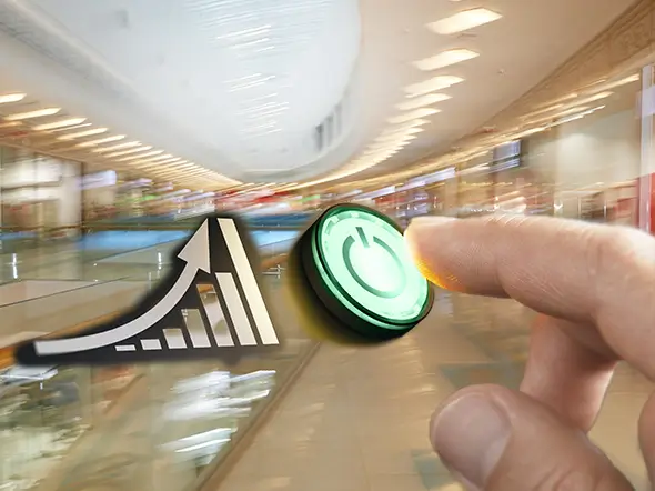 a bar chart heading upward and a hand pressing a glowing green on button. the background is a modern shopping mall with a blur effect