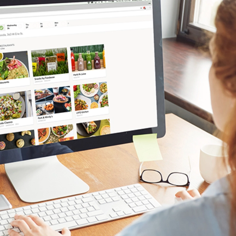 photo taken over the shoulder of a woman showing the Fooda ordering portal on her screen