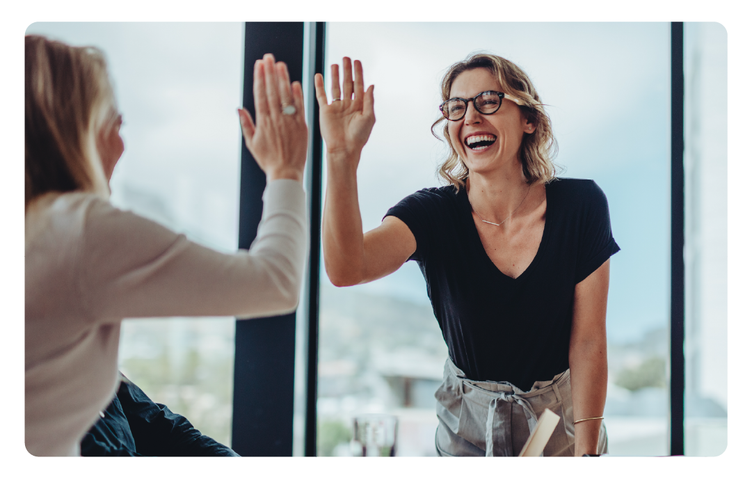 photo of two women giving a high-five