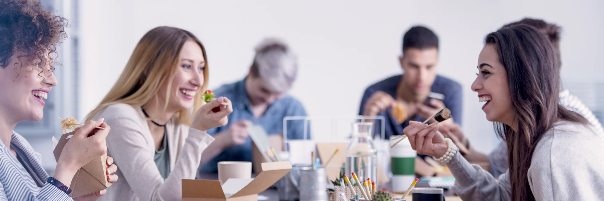 Photo of young coworkers bonding over lunch
