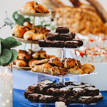 Beautiful catering layout with towers of pastries and desserts