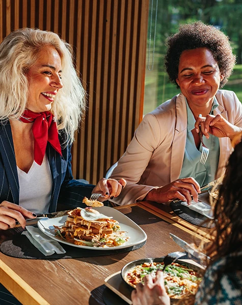Three coworkers enjoying a meal together.
