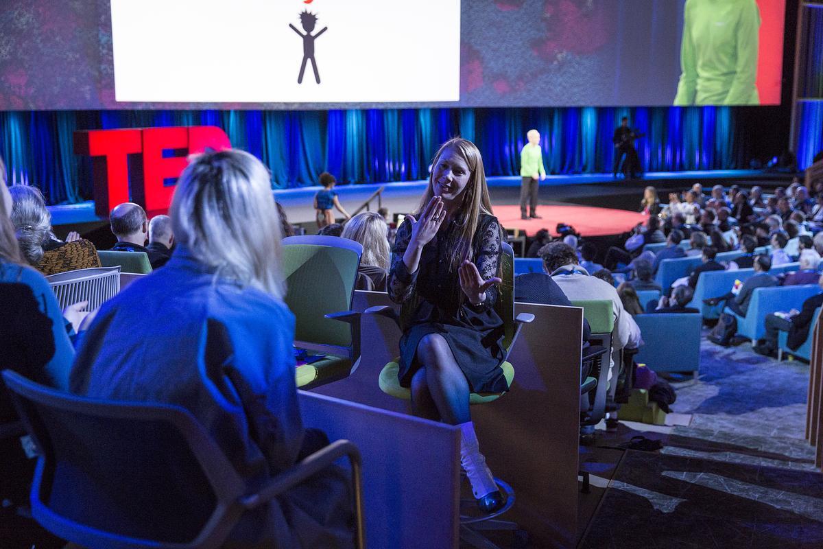 Person interpreting a TED Talk live in the theater
