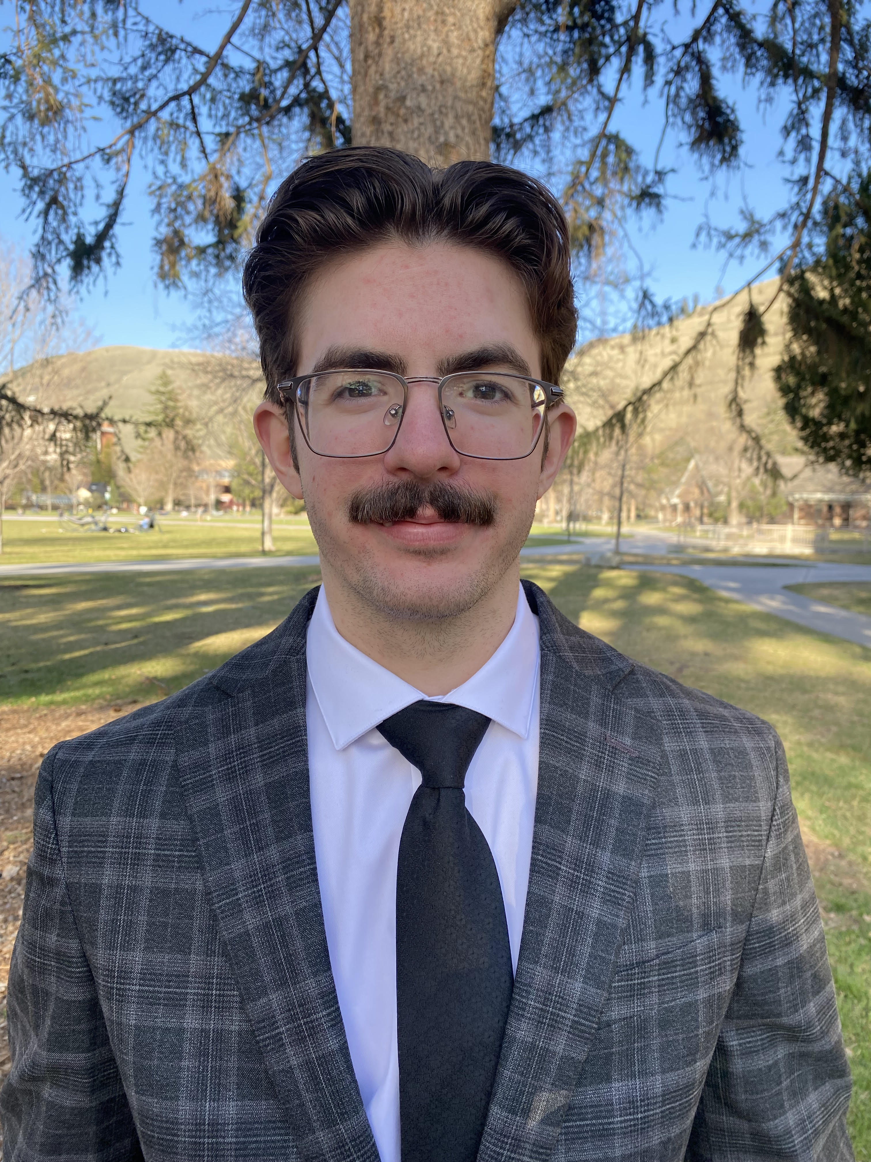 An image of the owner, marshall crawmer wearing a suit 