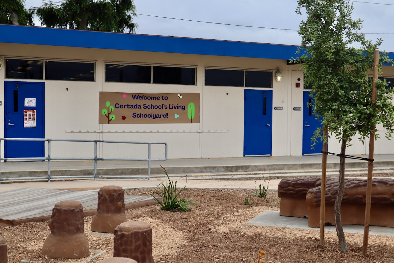 Cortada Elementary after renovation: new walking path lined with shade trees.