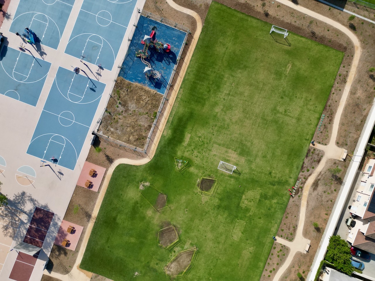 Cortada Elementary after renovation: green open space replacing former asphalt.