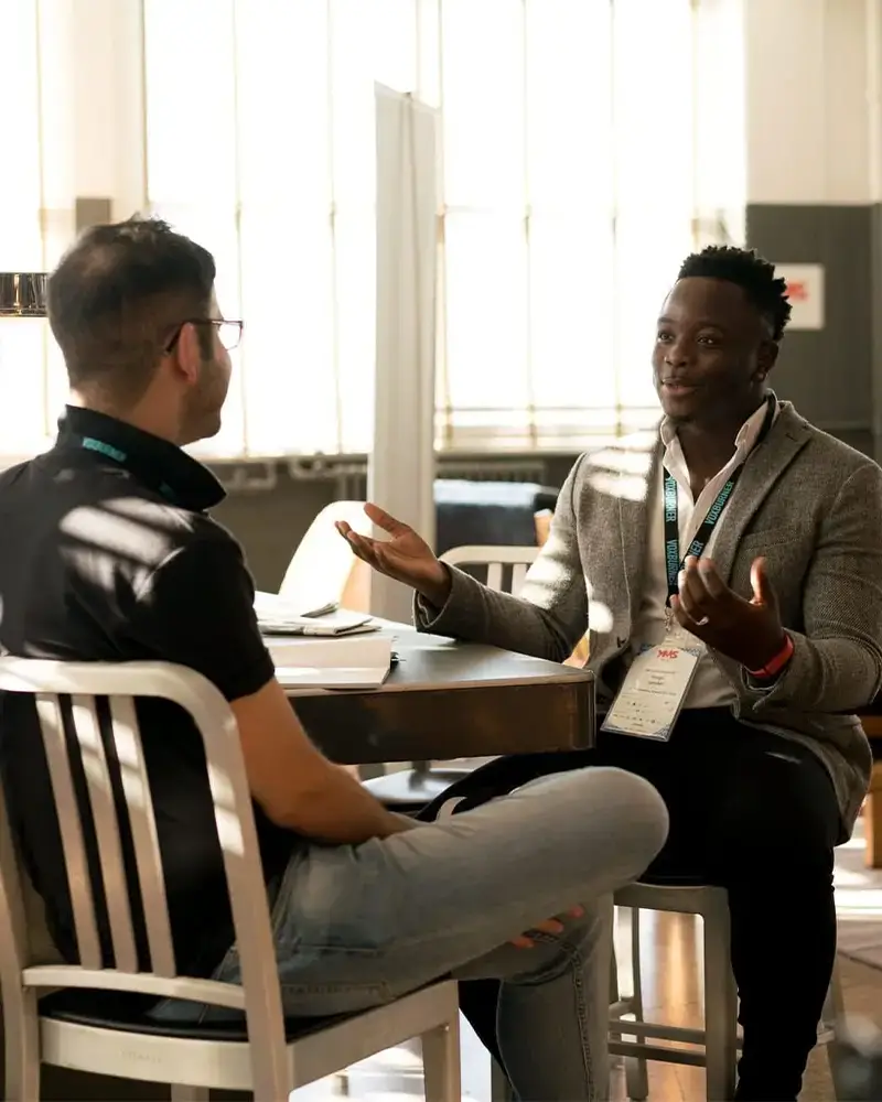 Two people meeting and discussing something with ease in a comfortable setting
