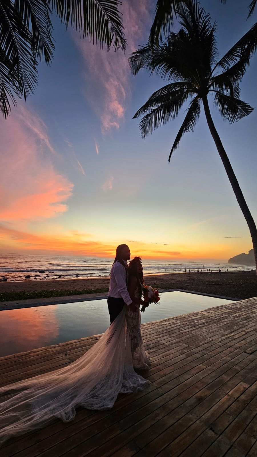 A newly married couple beside the Pacific at sunset in Mizata